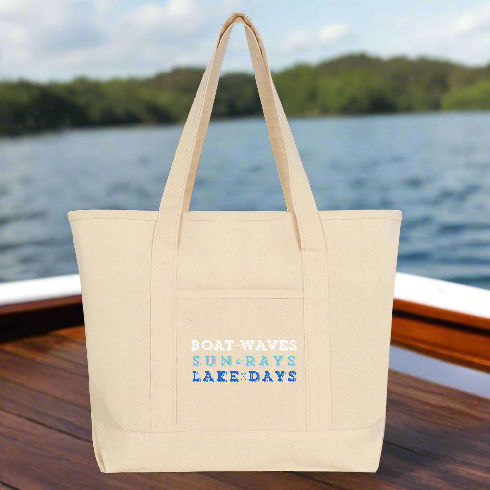 Beige tote bag with text on a wooden dock by a lake